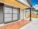 Close-up of a cozy front porch with tile flooring, decorative columns and a newly painted front door at 9201 Spy Glass Ct, Tampa, FL 33615