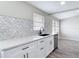 Kitchen with white cabinets, quartz countertops, a black faucet, and a stainless steel dishwasher at 9201 Spy Glass Ct, Tampa, FL 33615