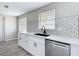Updated kitchen with white cabinets, quartz countertops, and stainless steel dishwasher at 9201 Spy Glass Ct, Tampa, FL 33615
