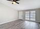 Open-concept living room with modern wood-look floors and a ceiling fan for energy efficiency at 9201 Spy Glass Ct, Tampa, FL 33615