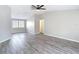 Bright living room with high ceilings, modern flooring, and ample natural light from large windows at 9201 Spy Glass Ct, Tampa, FL 33615