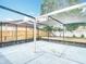 Spacious screened-in patio with concrete flooring, perfect for outdoor living and entertaining at 9201 Spy Glass Ct, Tampa, FL 33615