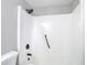Updated shower featuring modern fixtures and a white shower surround at 9201 Spy Glass Ct, Tampa, FL 33615