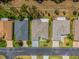 Birds-eye view of houses on a street showcasing their roofs, landscaping, and proximity in a residential area at 9723 Rolling Cir, San Antonio, FL 33576