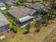 An aerial view of a backyard featuring a screened-in patio, complemented by a lawn and perimeter landscaping at 9723 Rolling Cir, San Antonio, FL 33576
