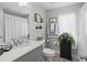 Well-lit bathroom with a single sink, decorative mirror, and modern fixtures at 9723 Rolling Cir, San Antonio, FL 33576