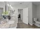Bright bathroom featuring double sinks, granite counters, and modern finishes at 9723 Rolling Cir, San Antonio, FL 33576