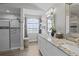 Elegant bathroom featuring double sinks, granite countertops, and a tiled shower at 9723 Rolling Cir, San Antonio, FL 33576