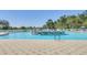Community pool with a fountain feature in the center, surrounded by lounge chairs and umbrellas at 9723 Rolling Cir, San Antonio, FL 33576