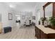 Elegant dining room with light wood floors, modern chandelier, and decorative dresser with marble top at 9723 Rolling Cir, San Antonio, FL 33576