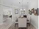 Dining room features a decorative light fixture, neutral walls, and hardwood floors at 9723 Rolling Cir, San Antonio, FL 33576