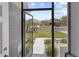 Inviting screened-in entryway leading to the front door with views of the neighborhood at 9723 Rolling Cir, San Antonio, FL 33576