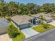 Charming single-story home featuring a well-manicured lawn and a neatly paved driveway leading to a two-car garage at 9723 Rolling Cir, San Antonio, FL 33576