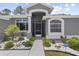 Welcoming front entrance with manicured landscaping and a charming front door at 9723 Rolling Cir, San Antonio, FL 33576