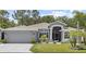 Charming single-story home with a two-car garage, mature landscaping, and a welcoming front entrance at 9723 Rolling Cir, San Antonio, FL 33576