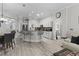 Spacious kitchen boasts stainless steel appliances, an island with seating, and sleek hardwood floors at 9723 Rolling Cir, San Antonio, FL 33576