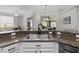 Close up of a kitchen featuring granite countertops, a modern sink and faucet, and ample outlets at 9723 Rolling Cir, San Antonio, FL 33576