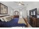Comfortable main bedroom featuring a ceiling fan, dark wood furniture, and decor at 9723 Rolling Cir, San Antonio, FL 33576