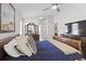 Comfortable main bedroom featuring a ceiling fan, dark wood furniture, and decor at 9723 Rolling Cir, San Antonio, FL 33576