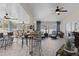 Spacious sunroom with brick flooring, ceiling fans, and ample seating areas at 9723 Rolling Cir, San Antonio, FL 33576