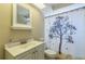 Cozy bathroom featuring vanity with bowl sink, toilet, and curtain with tree design at 10016 Glen Moor Ln, Port Richey, FL 34668