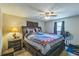 Cozy bedroom with a comfortable bed, ceiling fan, and bedside table with lamp at 10016 Glen Moor Ln, Port Richey, FL 34668