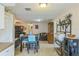 Open-concept dining room with a modern table and chairs, seamlessly flowing into the living area at 10016 Glen Moor Ln, Port Richey, FL 34668