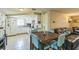 Combined kitchen and dining area featuring white appliances and a breakfast table at 10016 Glen Moor Ln, Port Richey, FL 34668