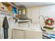 Functional laundry area with modern washer and dryer, shelving and storage space at 10016 Glen Moor Ln, Port Richey, FL 34668