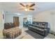 Spacious living room features a ceiling fan, tile floors, and ample seating at 10016 Glen Moor Ln, Port Richey, FL 34668