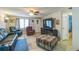 Open living room features tile flooring, comfortable seating, and a TV on a stand at 10016 Glen Moor Ln, Port Richey, FL 34668