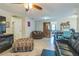 Inviting living room featuring tile floors, comfortable seating, and a decorative fireplace at 10016 Glen Moor Ln, Port Richey, FL 34668