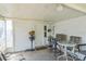 Enclosed patio features a ceiling and a seating area for outdoor relaxation at 10016 Glen Moor Ln, Port Richey, FL 34668