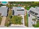An aerial view of the home and lot, showing the pool, updated roof, and mature landscaping at 10448 Hetrick W Cir, Largo, FL 33774