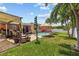 Spacious backyard showcasing a pool, patio, and lush lawn at 10448 Hetrick W Cir, Largo, FL 33774