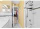 Well-lit bathroom with white subway tile, glass shower, and decorative accents at 10448 Hetrick W Cir, Largo, FL 33774