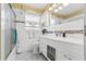 Bright bathroom with a white vanity, updated fixtures, and a glass-enclosed shower at 10448 Hetrick W Cir, Largo, FL 33774