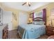 Bright bedroom with warm tones, showcasing a window, bed with decorative pillows, and wood furnishings at 10448 Hetrick W Cir, Largo, FL 33774