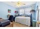 Bedroom in pastel blue with decorative accents, featuring a wrought iron bed, and natural light at 10448 Hetrick W Cir, Largo, FL 33774