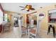 Cozy dining room showcasing a glass table, bright lighting, and seamless access to the kitchen at 10448 Hetrick W Cir, Largo, FL 33774