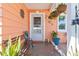 Front porch of the home with decorative plants, and a bench at 10448 Hetrick W Cir, Largo, FL 33774