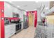 Well-equipped kitchen with stainless steel appliances, granite counters, and ample cabinetry at 10448 Hetrick W Cir, Largo, FL 33774