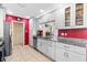 Bright kitchen featuring stainless steel appliances and granite countertops at 10448 Hetrick W Cir, Largo, FL 33774
