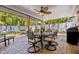Outdoor patio area featuring a ceiling fan, dining set, and stylish decor at 10448 Hetrick W Cir, Largo, FL 33774