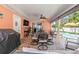 Outdoor patio area featuring a grill, dining set, and comfortable seating at 10448 Hetrick W Cir, Largo, FL 33774