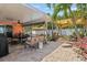 Back patio with a dining area, lounge seating, and a view of the pool at 10448 Hetrick W Cir, Largo, FL 33774