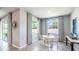 Bright breakfast nook with large windows, a round table, and modern light fixtures at 10645 Bridgegate Heights Loop, San Antonio, FL 33576