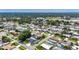 Aerial view of a neighborhood featuring single-Gathering homes, a pool, and lush landscaping and a lake at 12933 90Th Ave, Seminole, FL 33776