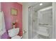 Bathroom featuring tiled shower with bench seat and safety handle at 12933 90Th Ave, Seminole, FL 33776