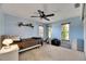 Comfortable bedroom featuring a ceiling fan, ample natural light, and neutral carpet at 12933 90Th Ave, Seminole, FL 33776